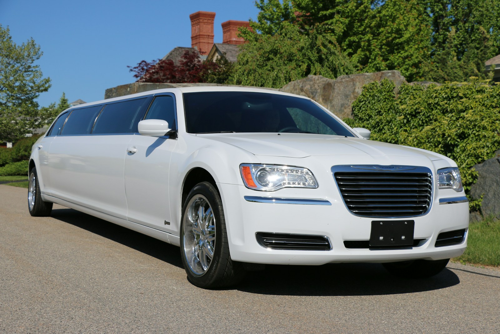 a white car parked on the side of a road, limousine